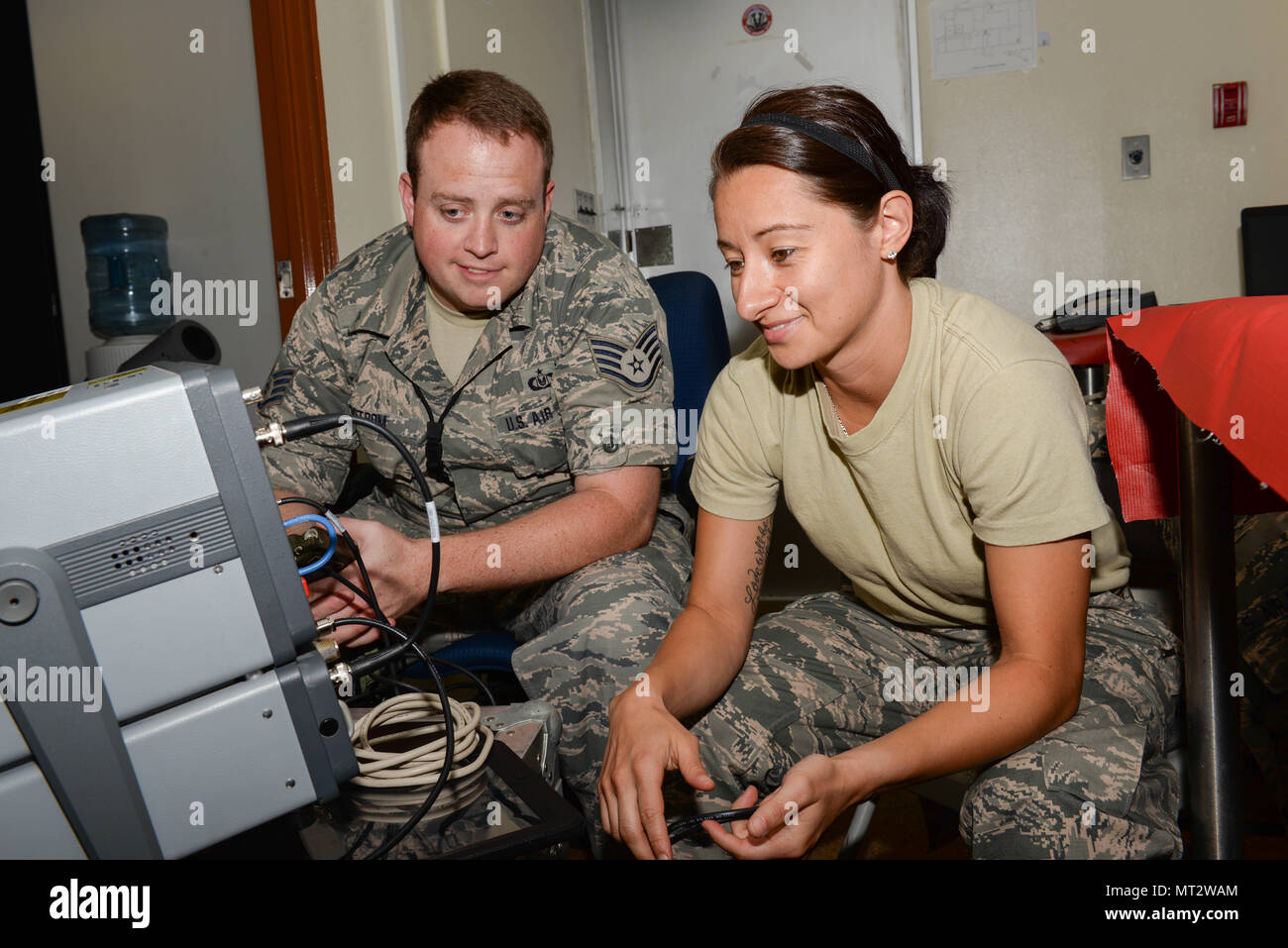 Le sergent de l'US Air Force. Michael Ostrom et le sergent. Katia Cordonaldana, les techniciens d'équipement de vol du personnel navigant affecté à la 140e Escadre, Colorado Air National Guard, effectuer la maintenance de routine des chèques sur un transpondeur radio fixé à Kadena Air Base, le Japon, le 6 juin 2017. Les deux aviateurs sont soutenant la routine Theatre Support Package chargé d'aider à maintenir la stabilité et la sécurité dans la région du Pacifique. (U.S. Photo de la Garde nationale aérienne par le personnel. Le Sgt. Bobbie Reynolds) Banque D'Images