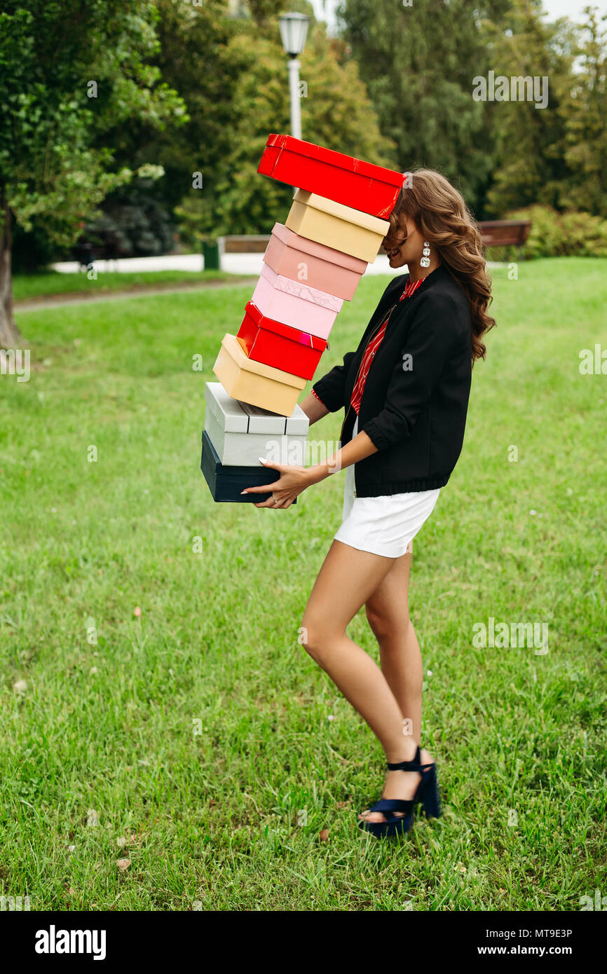 Fille avec boîtes à chaussures tomber vers le bas pendant qu'elle marche  sur la pelouse Photo Stock - Alamy