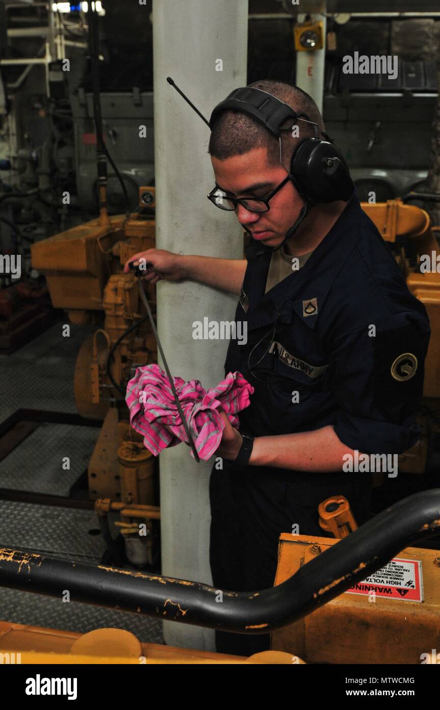La FPC. Kenneth Sheffler, une motomarine ingénieur à la 411e Détachement de transport, vérifie les niveaux de fluide moteur du navire de soutien logistique de l'Armée Le Général cinq Charles P. Gross, lors d'une mission de transport dans la région du Golfe 20 janvier 2017. L'équipage du fret transporté à Qatar du port de Shuaiba, Koweït et transporté une autre charge pendant le voyage de retour. Même en l'équipage pratiqué plusieurs exercices d'urgence maritime y compris l'homme à la mer, le feu, et les exercices de combat. L'équipage était composé de conducteurs de motomarine, ingénieurs, médecins, cuisiniers, et bien que chaque membre est formé à se Banque D'Images