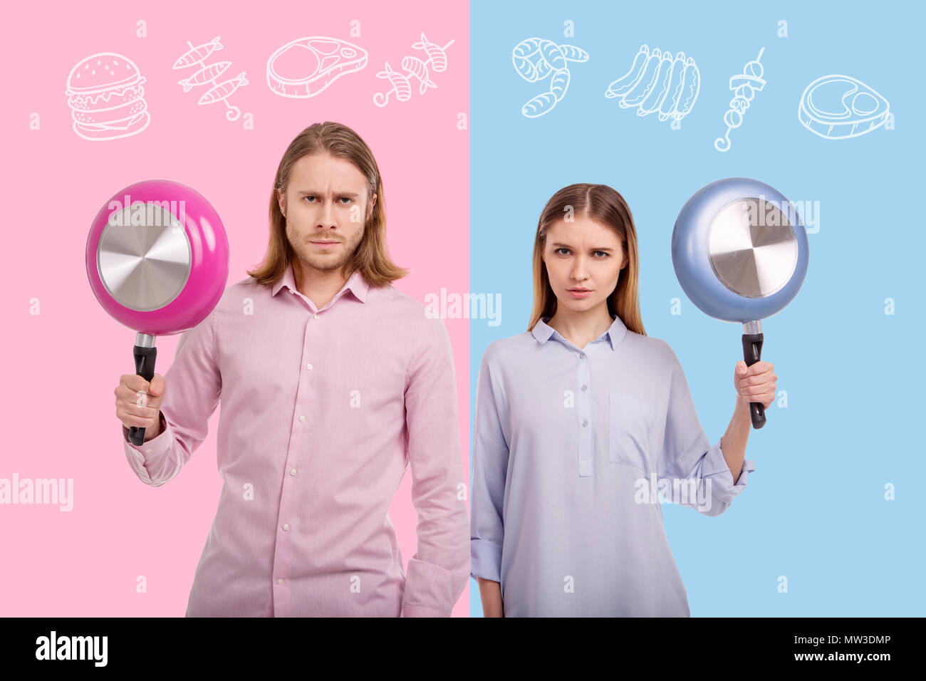 Les jeunes gens sérieux maintenant des poêles à frire et à la prête pour la cuisson Banque D'Images