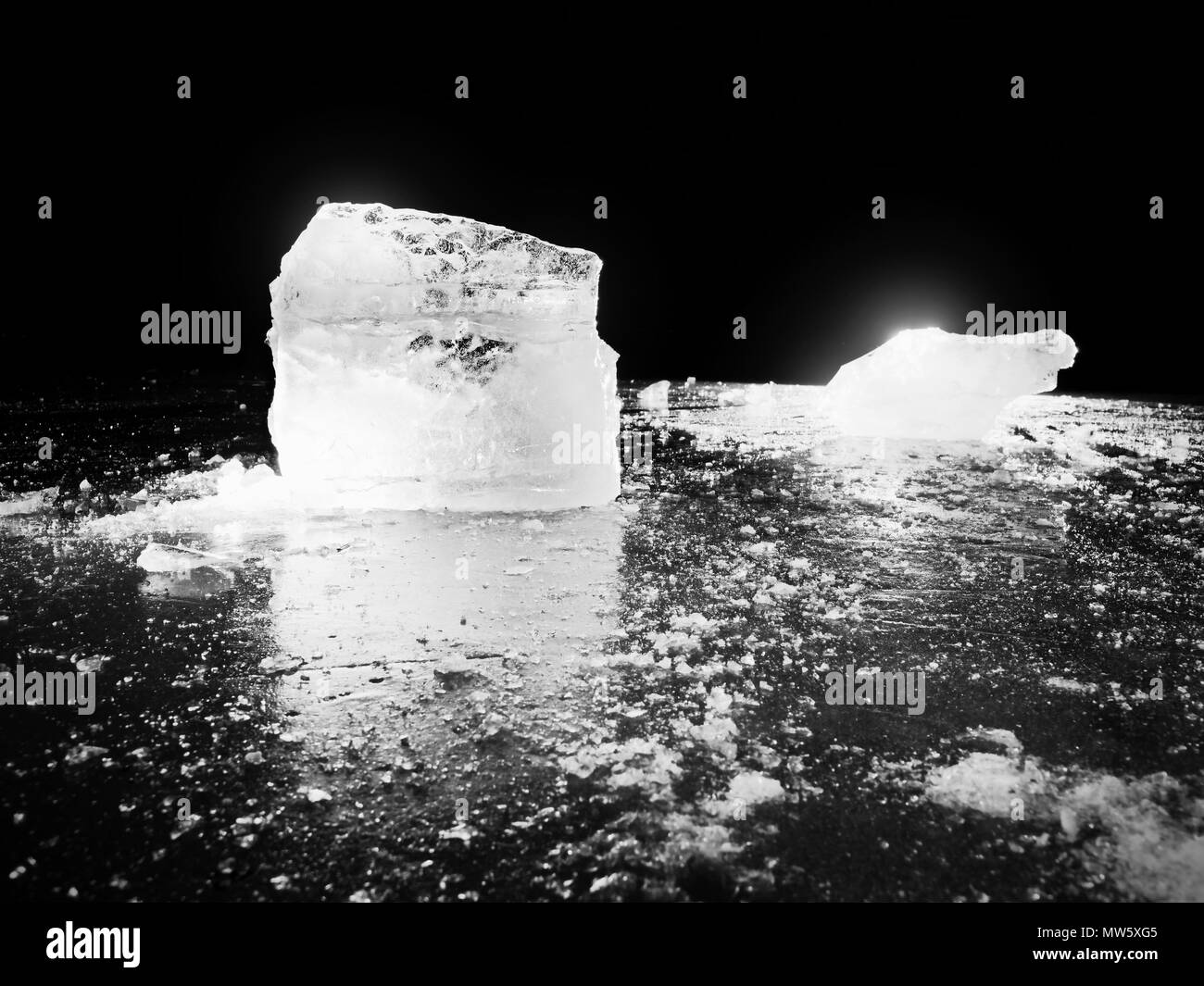 Glace avec réflexion sur le lac. Banc de glace concassée réfléchissant sur fond naturel. Iceberg naturelles avec la profondeur de champ. Photo en noir et blanc. Banque D'Images