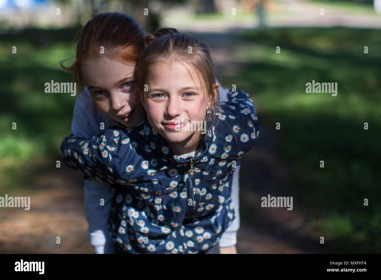 Deux filles soeurs ou amies s'amuser en plein air. Recherche dans l'appareil. Banque D'Images