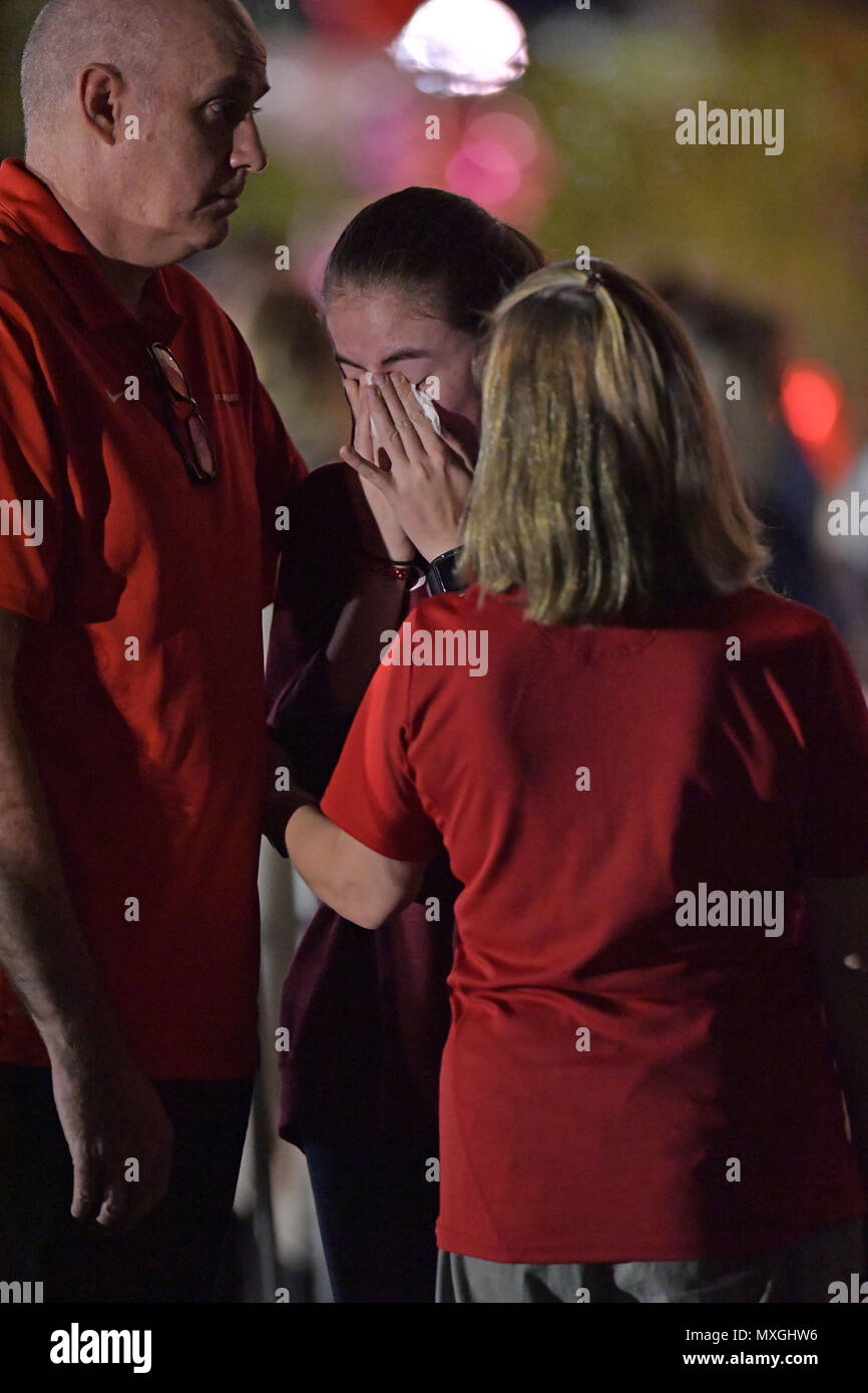 Parc, FL, USA. 16 Février, 2018. Une jeune femme met des fleurs sur un mémorial qui honore les victimes de la prise de masse à l'école secondaire Marjory Stoneman Douglas, à Pine Trail Park le 16 février 2018 dans un parc, en Floride. La police a arrêté 19 ans, ancien élève Nikolas Cruz pour avoir tué 17 personnes à l'école secondaire. Personnes : Atmosphère Crédit : Hoo Punch/Me.Com/Media Alamy Live News Banque D'Images