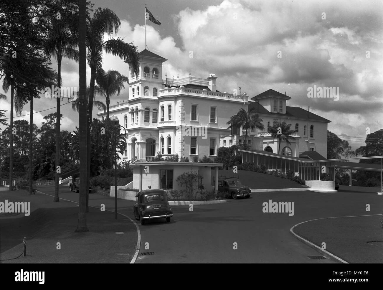 La Maison du gouvernement, Brisbane, mars 1954. Johann Heussler, un riche commerçant de Brisbane achète 22 acres de terres de la part du gouvernement en 1862 et fait des plans pour construire une maison là-bas. L'architecte local Benjamin Backhouse conçu une maison en 1865, à être construit en pierre creusée sur place combiné avec un mélange de ciment et de chaux. La famille vivait à Heussler Fernberg à partir de 1865 jusqu'en 1872 lorsque le coût élevé de l'entretien la forclusion des forces canadiennes sur la propriété par le créancier hypothécaire. Sir Arthur Palmer, Premier Ministre du Queensland (1870-1874), et plus tard lieutenant-gouverneur résidait à Fernberg de 1872 à 1881. John Banque D'Images