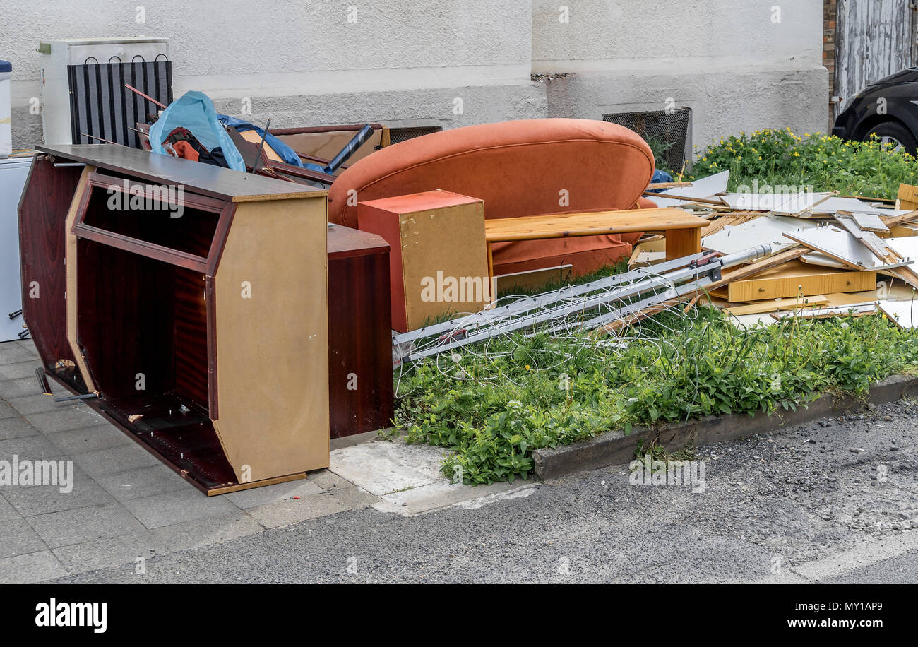 Déchets encombrants avec placards, un canapé et des meubles sur la pelouse en face d'un immeuble à appartements, Allemagne Banque D'Images