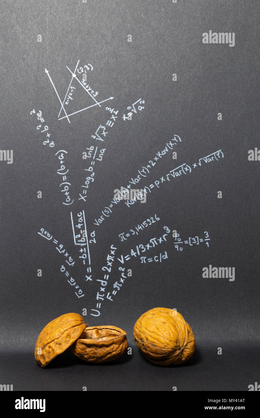 Concept de l'expression mathématiques en un mot. Des formules mathématiques tirés sur papier noir aux noix Banque D'Images