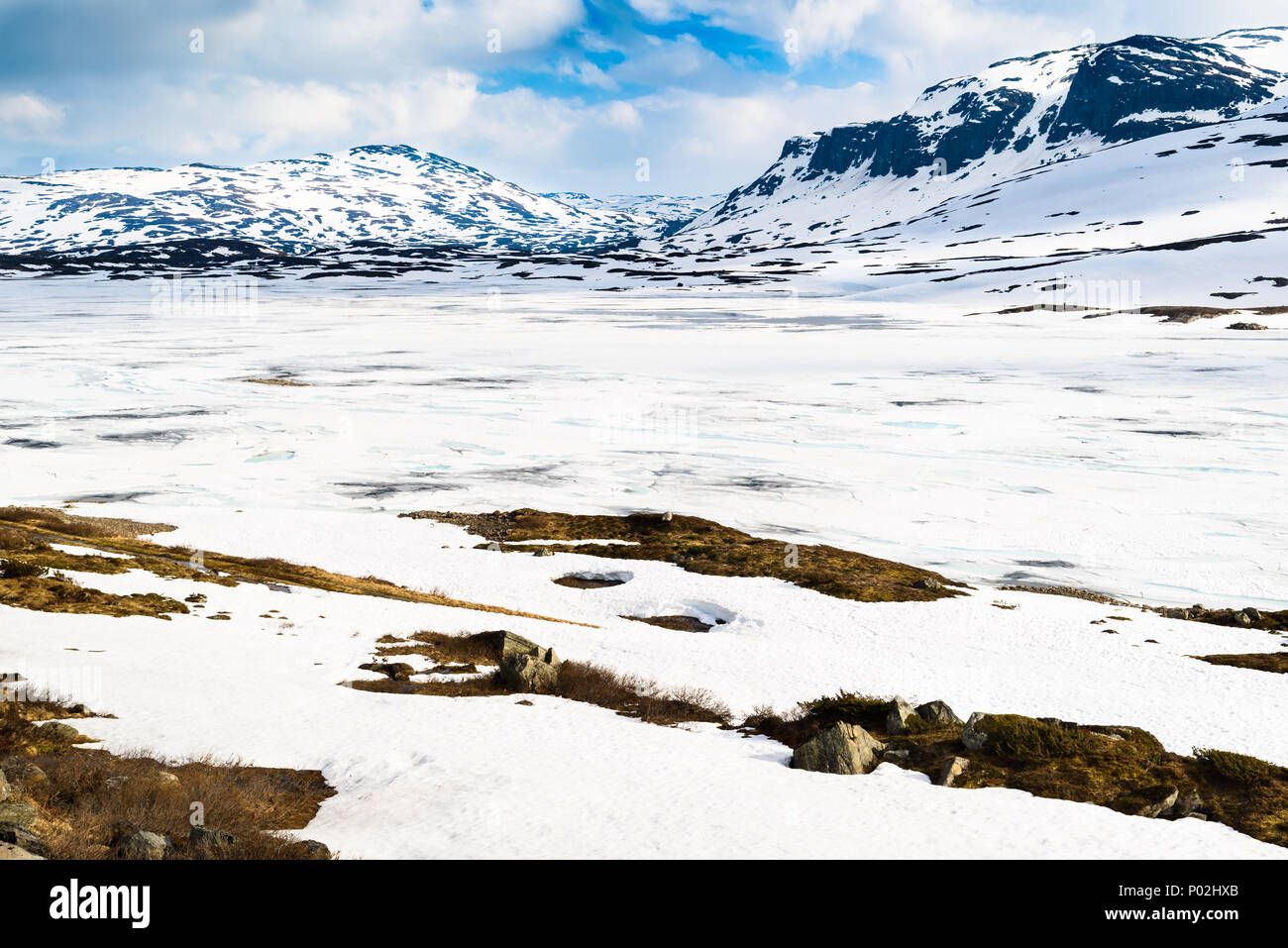 Lac gelé au dégel de la glace et de la neige. Montagnes en arrière-plan. Lac Stavatn Emplacement en Telemark, Norvège. Banque D'Images