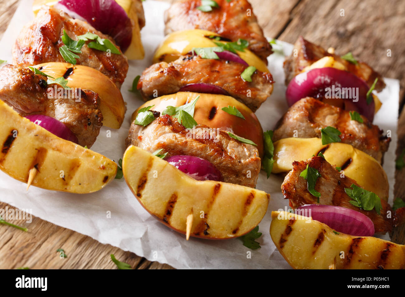 Délicieux kebab grillé avec des pommes fraîches et l'oignon rouge en brochettes sur la table horizontale. Banque D'Images