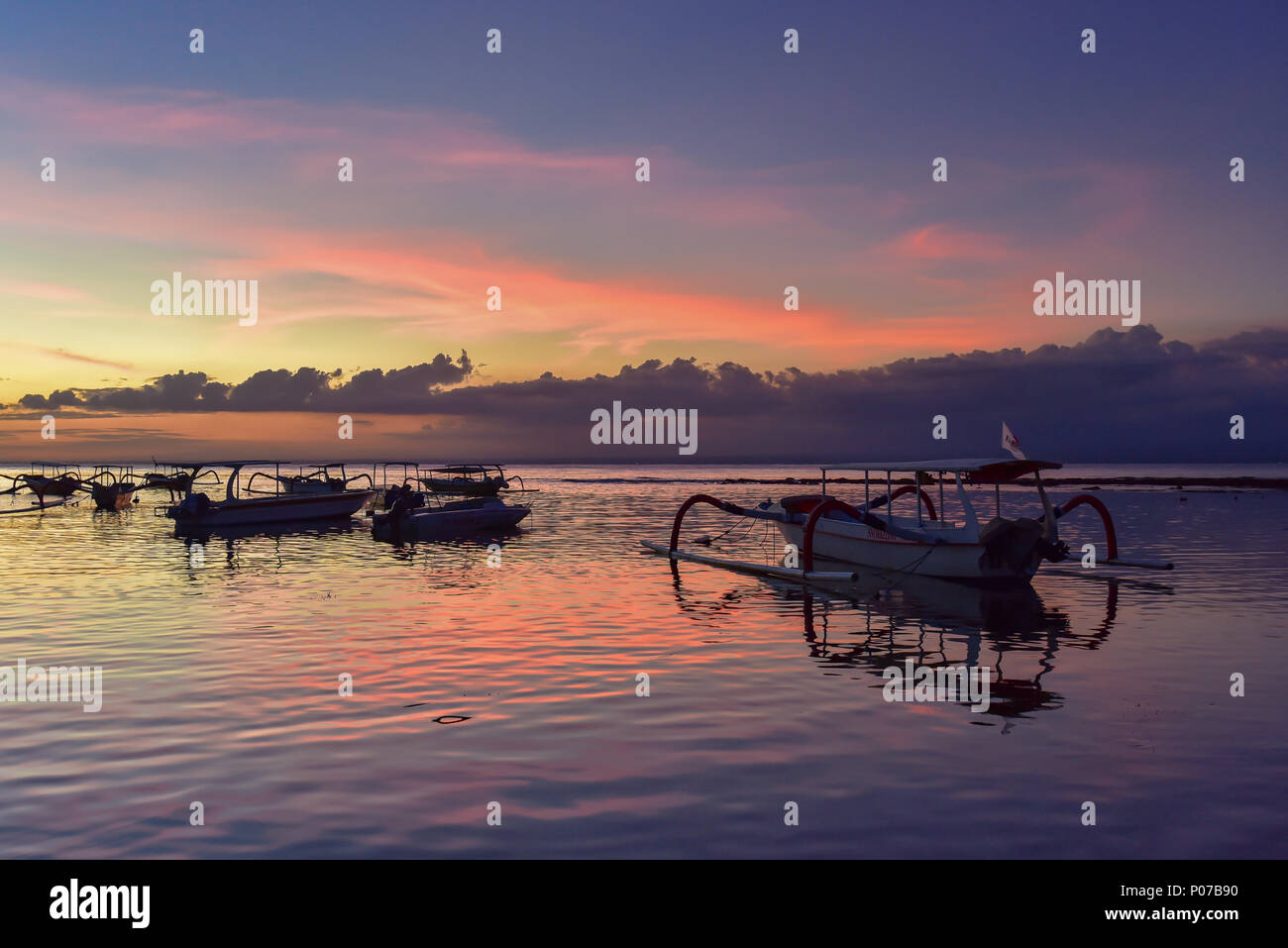 Coucher de soleil à Mushroom Beach avec des bateaux sur la mer, Lembongan, Bali, Indonésie Banque D'Images