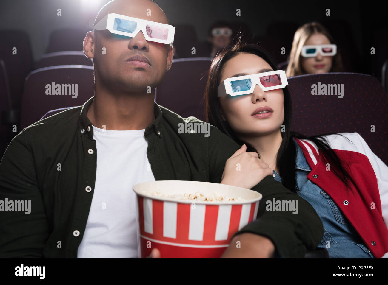 Jeune couple interracial dans les lunettes 3d avec pop-corn regarder la  vidéo dans le cinéma Photo Stock - Alamy