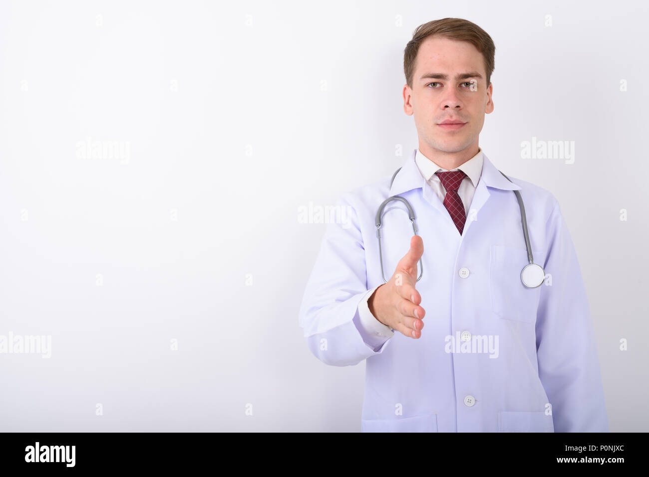 Jeune homme séduisant médecin contre fond blanc Banque D'Images