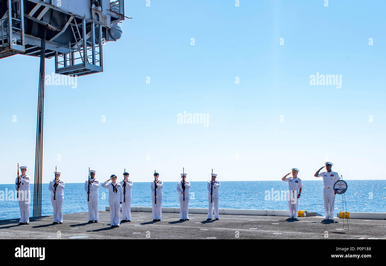 180606-N-UV609-0148 de l'OCÉAN ATLANTIQUE (6 juin 2018) Le capitaine Sean Bailey, commandant du porte-avions USS George H. W. Bush (CVN 77) et Master Chef Conseiller Marine Tyrone Jiles commandement par intérim chef principal, avec le fusil détail rendre un hommage comme pre est joué au cours d'une cérémonie du souvenir du 76e anniversaire de la Bataille de Midway. Le navire est en cours d'entraînement de routine des exercices pour maintenir l'état de préparation de l'opérateur. (U.S. Photo par marine Spécialiste de la communication de masse 2e classe David Mora Jr.) Banque D'Images