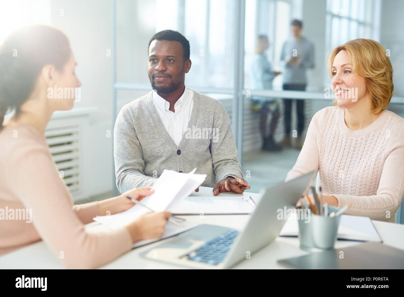 Réunion de travail à pleine vitesse : équipe multi-ethnique de cols blancs assis à table des open plan office et de remue-méninges sur projet commun Banque D'Images