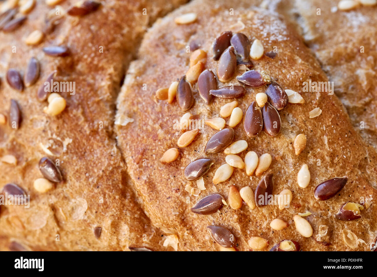 Close up photo d'une croûte de pain de blé entier avec du lin et graines de sésame, selective focus. Banque D'Images