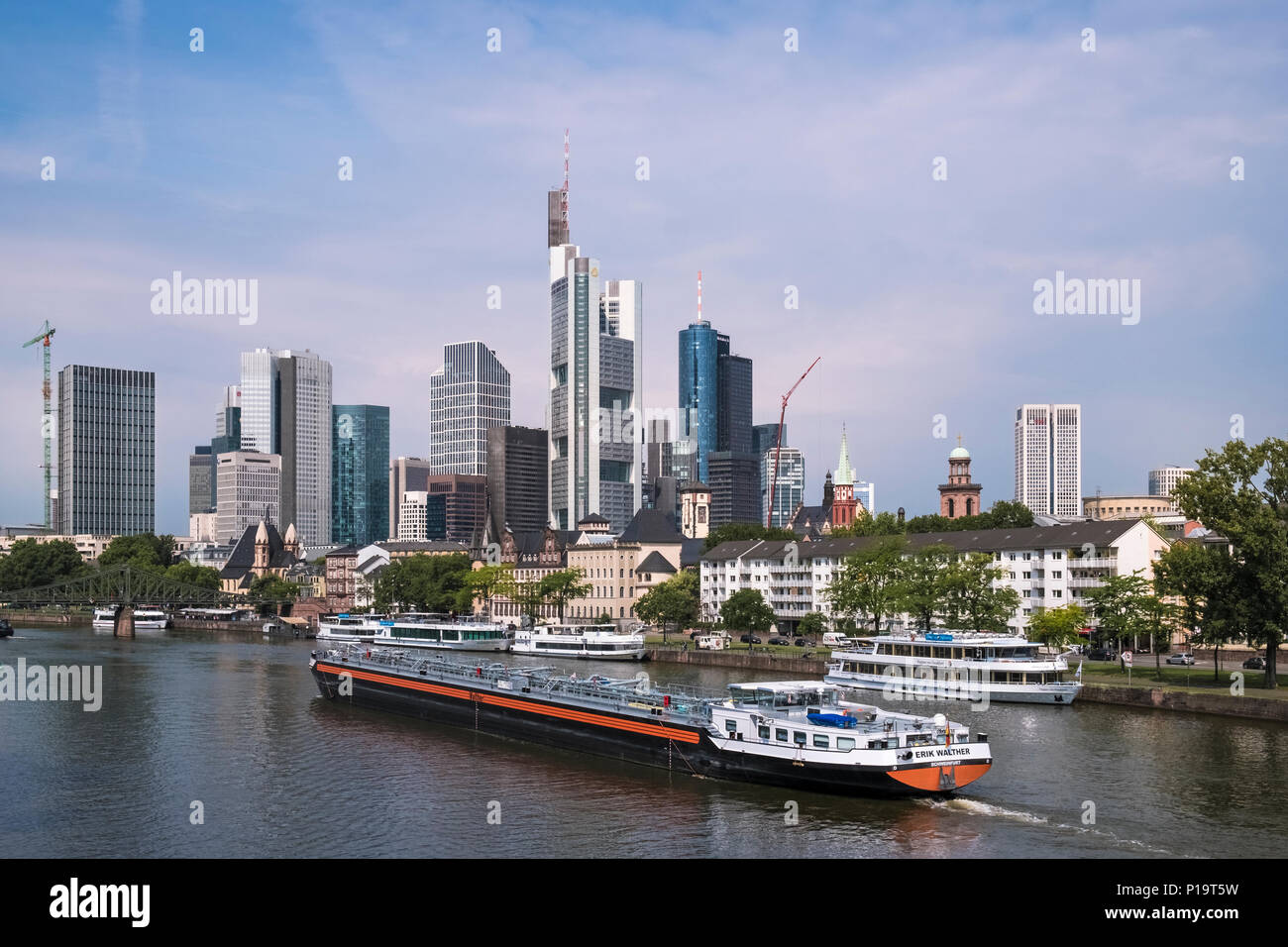 Une grande barge voyages sur la rivière Main, passé la ligne d'horizon gratte-ciel l'architecture moderne de la ville, Frankfurt am Main, Hesse, Allemagne Banque D'Images