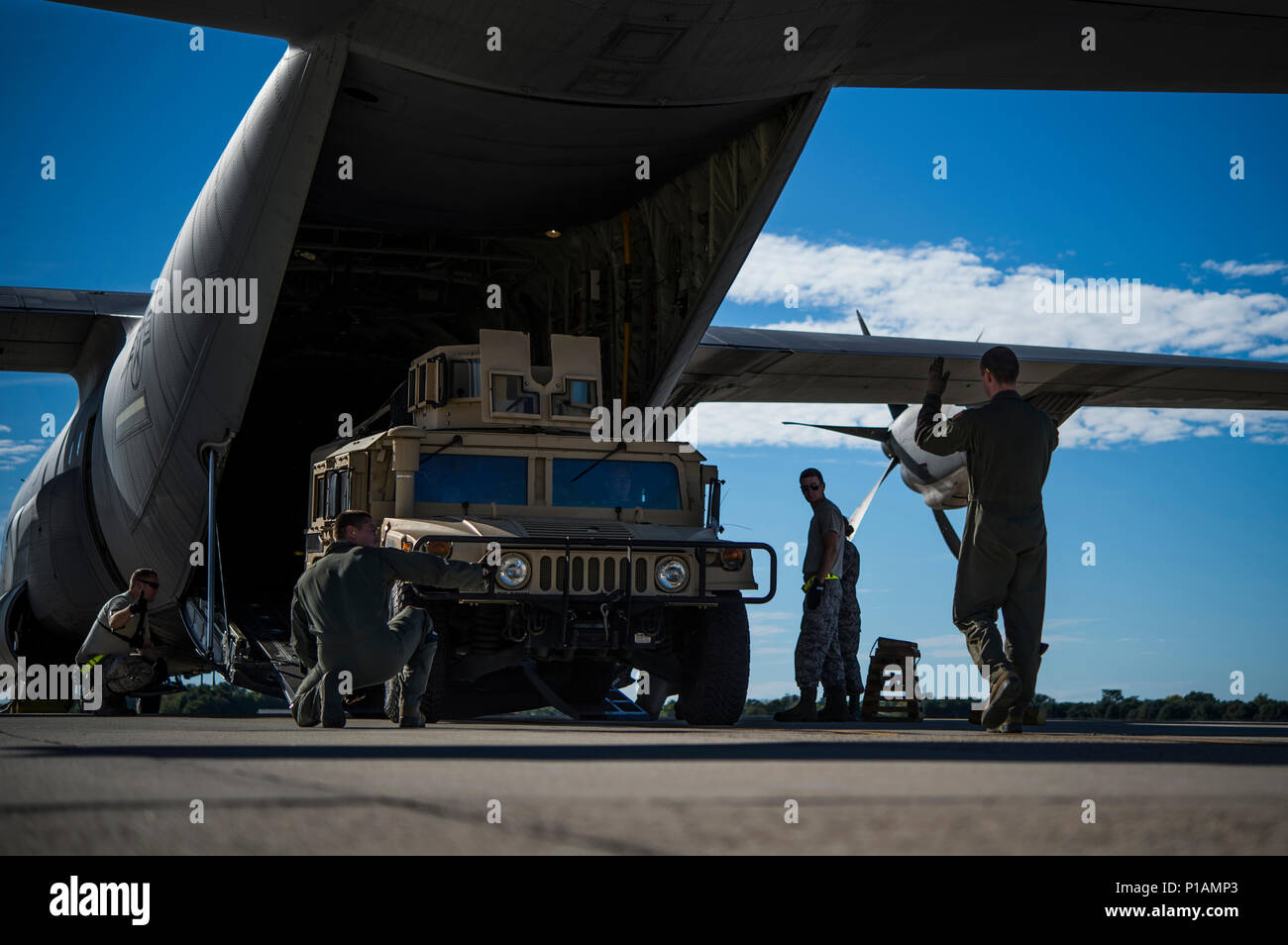 Les membres du 305e Escadron de Port de l'antenne d'un plan d'intervention de charge 621e aile sur un Humvee C-130 Hercules à Joint Base McGuire-Dix-Lakehurst, N.J., le 7 octobre 2016, à la suite de l'Ouragan Matthew. Le CRW dispose d'unités en continu sur alerte et prêt à se déployer partout dans le monde à l'appui des opérations d'urgence, comme l'ouragan d'urgence, dans les 12 heures de notification. (U.S. Air Force photo de Tech. Le Sgt. Gustavo Gonzalez/libérés) Banque D'Images