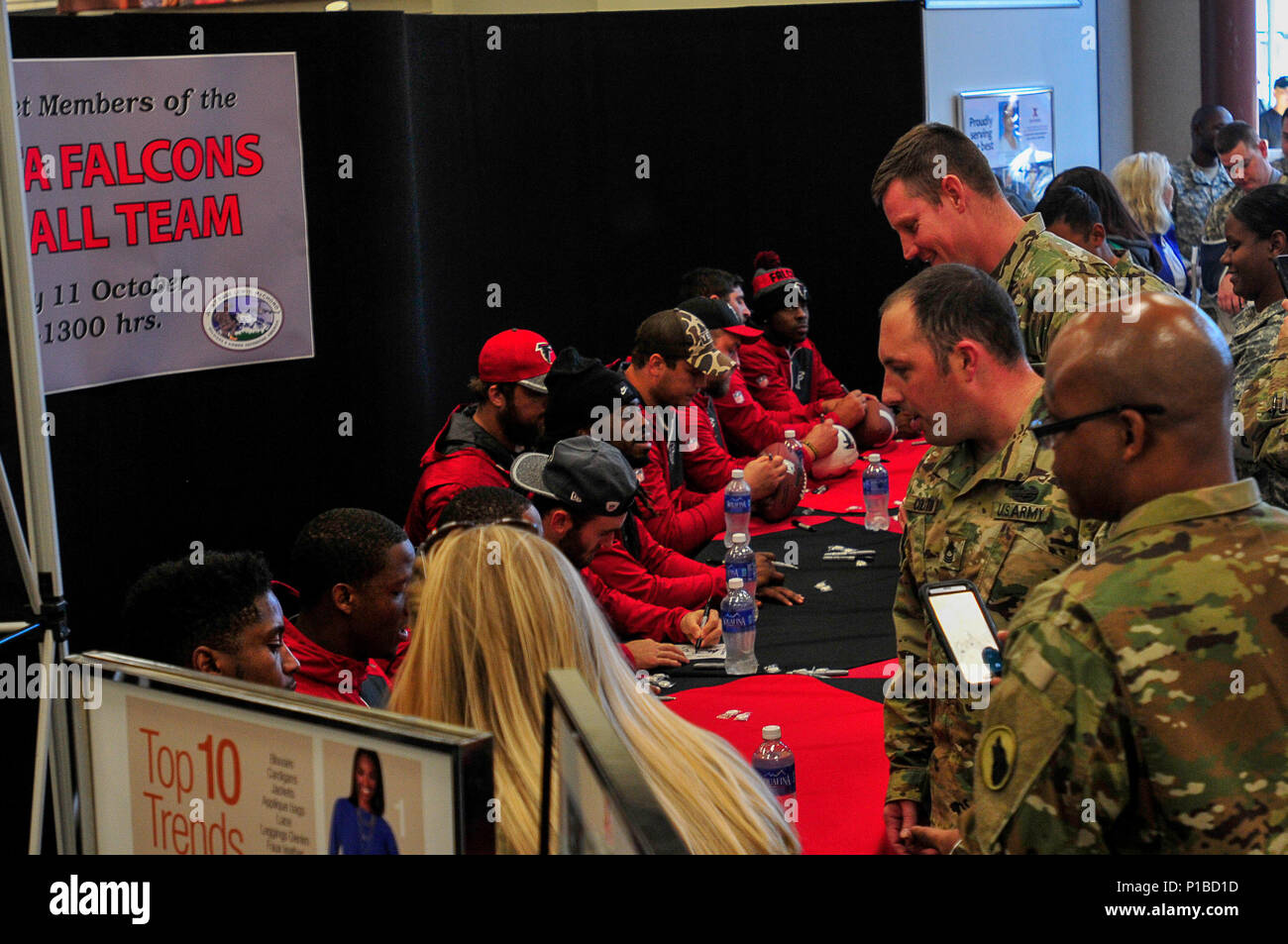 Membres de l'équipe avec les Falcons d'Atlanta a pris le temps de leur horaire pour signer des autographes et parler avec les membres et leurs familles stationnés à Joint Base Lewis-McChord, Washington, le 11 octobre. Les membres ont observé un expert infantryman badge et de la concurrence a mené une rencontrez et grande à l'échange de poste. (U.S. Photo de l'armée par le Sgt. Christopher Prows, 5e MPAD) Banque D'Images