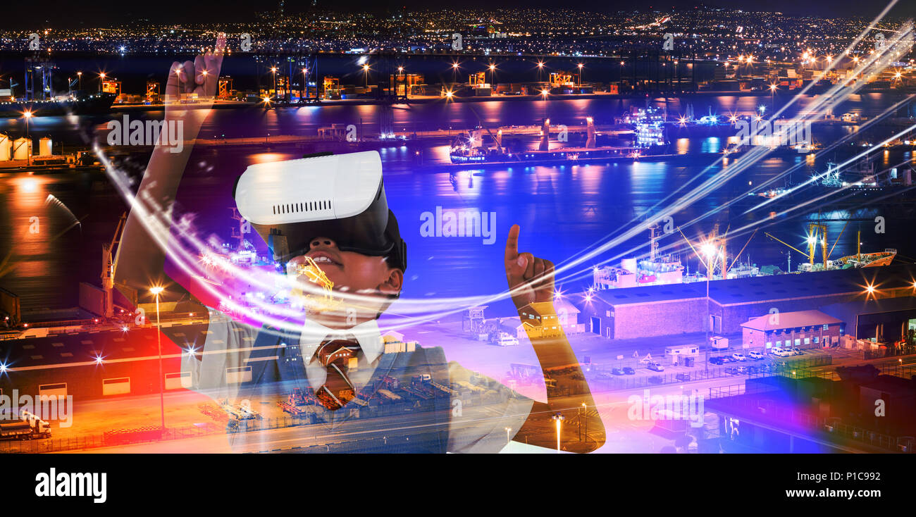 Image composite de l'écolier le port de casque de réalité virtuelle bénéficiant Banque D'Images