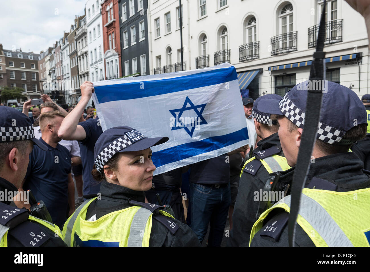 Manifestants d'opposition tenir un drapeau israélien lors de l'Al-Quds Day rally. Le Al-Quds Day rally est un événement qui est censé mettre en lumière le sort du peuple palestinien et de faire prendre conscience de la persécution islamique à travers le monde. Le rassemblement a suscité des controverses à travers le Royaume-Uni parce que présentateurs de l'événement appel ouvertement à la destruction d'Israël et certains participants brandir le drapeau du Hezbollah, un groupe terroriste. Banque D'Images