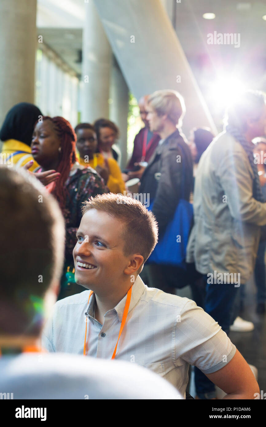 Smiling woman networking at conference Banque D'Images