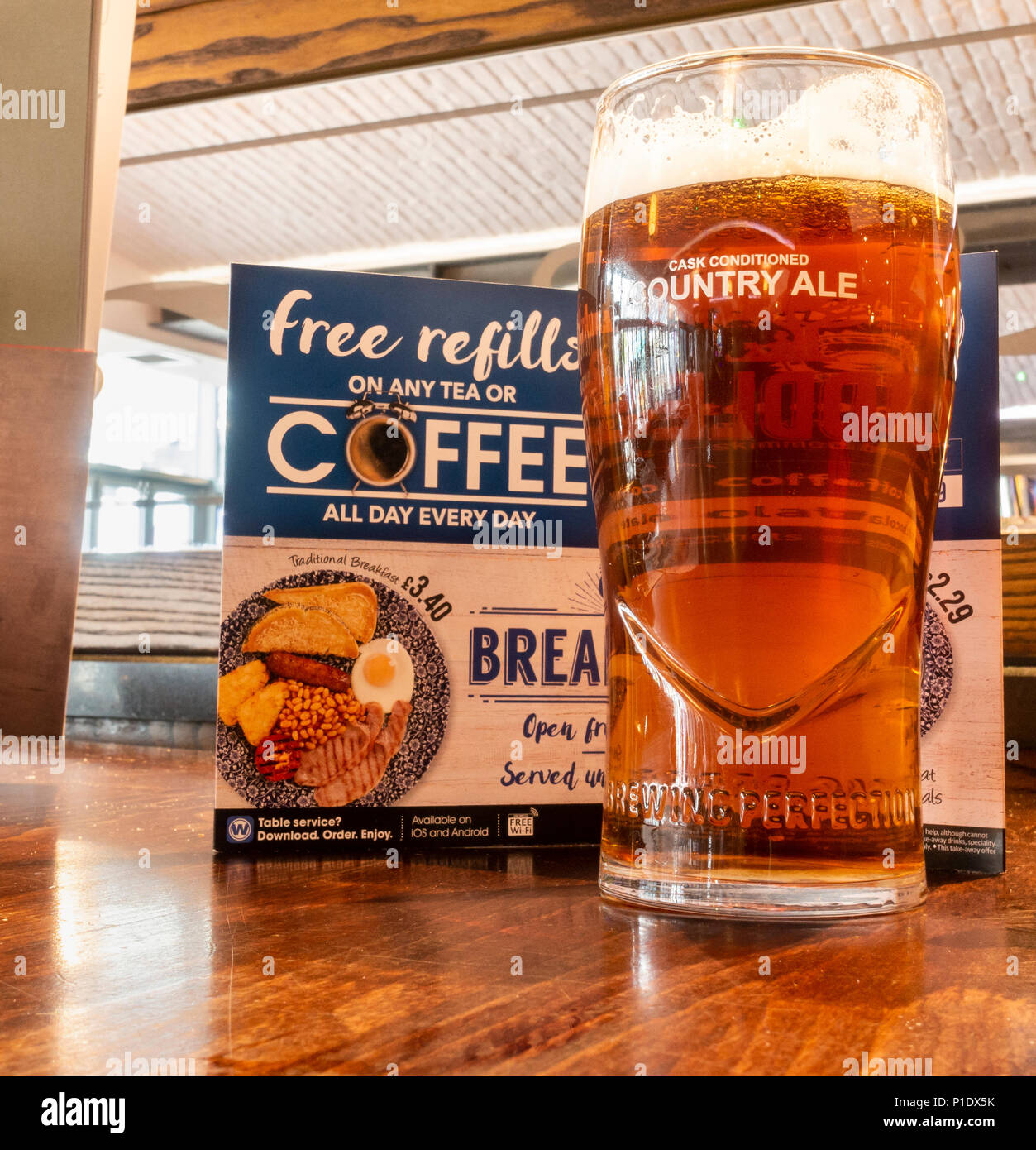 Une pinte de bière artisanale en face de menu dans JD Wetherspoon pub en Angleterre. UK Banque D'Images
