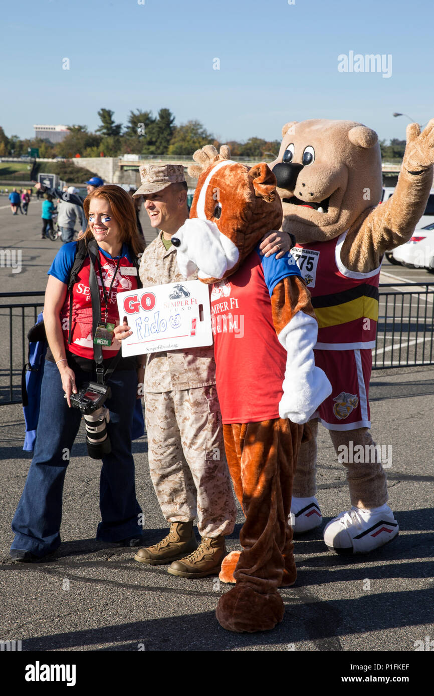 Le colonel marin Joseph M. Murray pose avec les mascottes de la race, de l'Fido Semper Fi Fonds et Miles, du Marine Corps Marathon (MCM), au Kid's Run, hébergé par le MCM qui présente de la musique et de divertissement, Arlington, Md., 29 octobre, 2016. Le Kid's Run a coïncidé avec le 41ème GCM, pour générer la bonne volonté dans la communauté, de promouvoir la santé et la forme physique, et de mettre en valeur les compétences organisationnelles du Marine Corps. (U.S. Marine Corps photo par le Sgt. Jean Raufmann) Banque D'Images