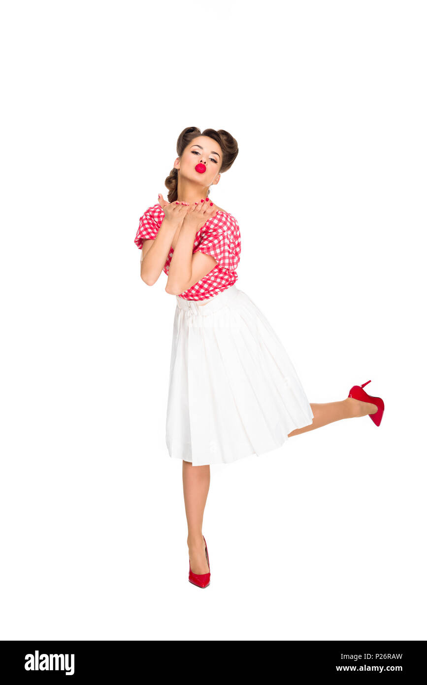 Belle jeune femme en vêtements de style rétro blowing kiss isolated on  white Photo Stock - Alamy