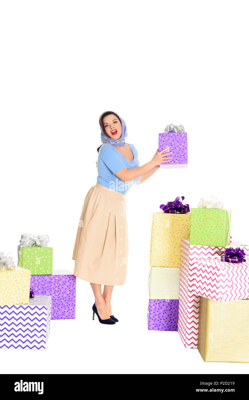 Belle jeune femme élégante holding present and looking at camera isolated on white Banque D'Images