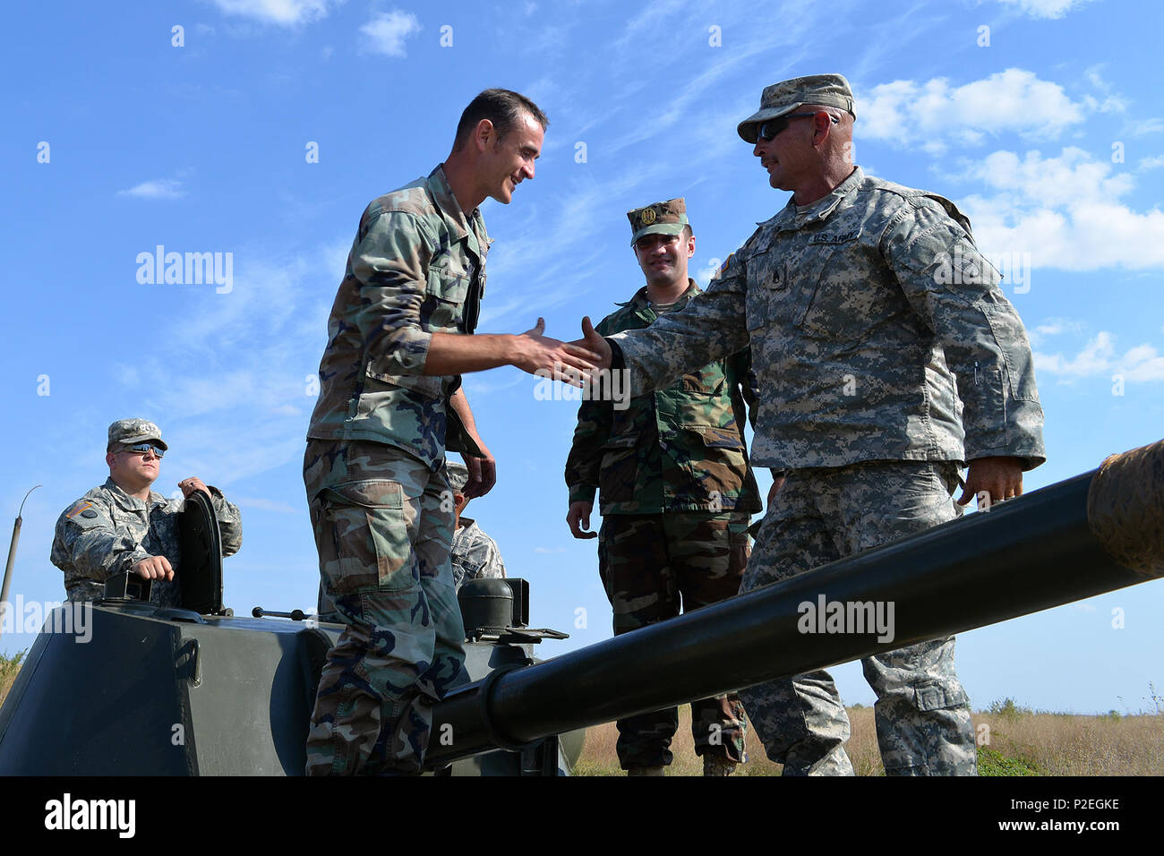 Un soldat américain affecté à la Garde nationale de l'armée de Caroline du Nord accueille un soldat moldave lors d'un événement de familiarisation aux armes dans la zone d'entraînement de Bulboaca en Moldavie. L’interaction a lieu dans le cadre de Fire Shield 2016, un exercice multinational axé sur l’établissement de partenariats, l’amélioration de la communication, la promotion de l’interopérabilité, l’amélioration des compétences tactiques et le renforcement des relations entre les forces américaines et les partenaires européens dans les opérations d’artillerie et d’infanterie. Banque D'Images