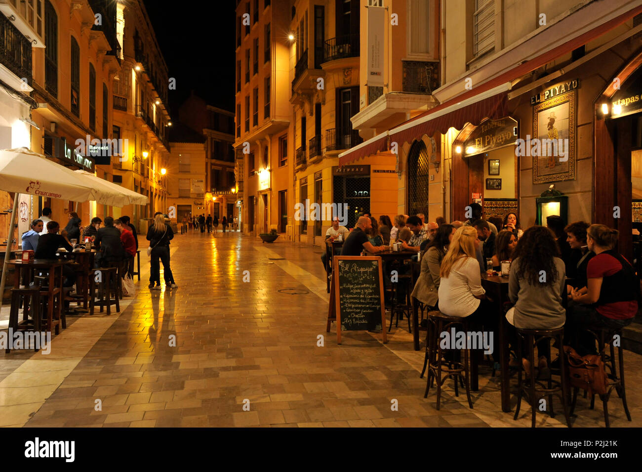 Alley avec des restaurants et des tables à proximité de la cathédrale de Malaga dans la lumière du soir, Malaga, Andalousie, Espagne Banque D'Images