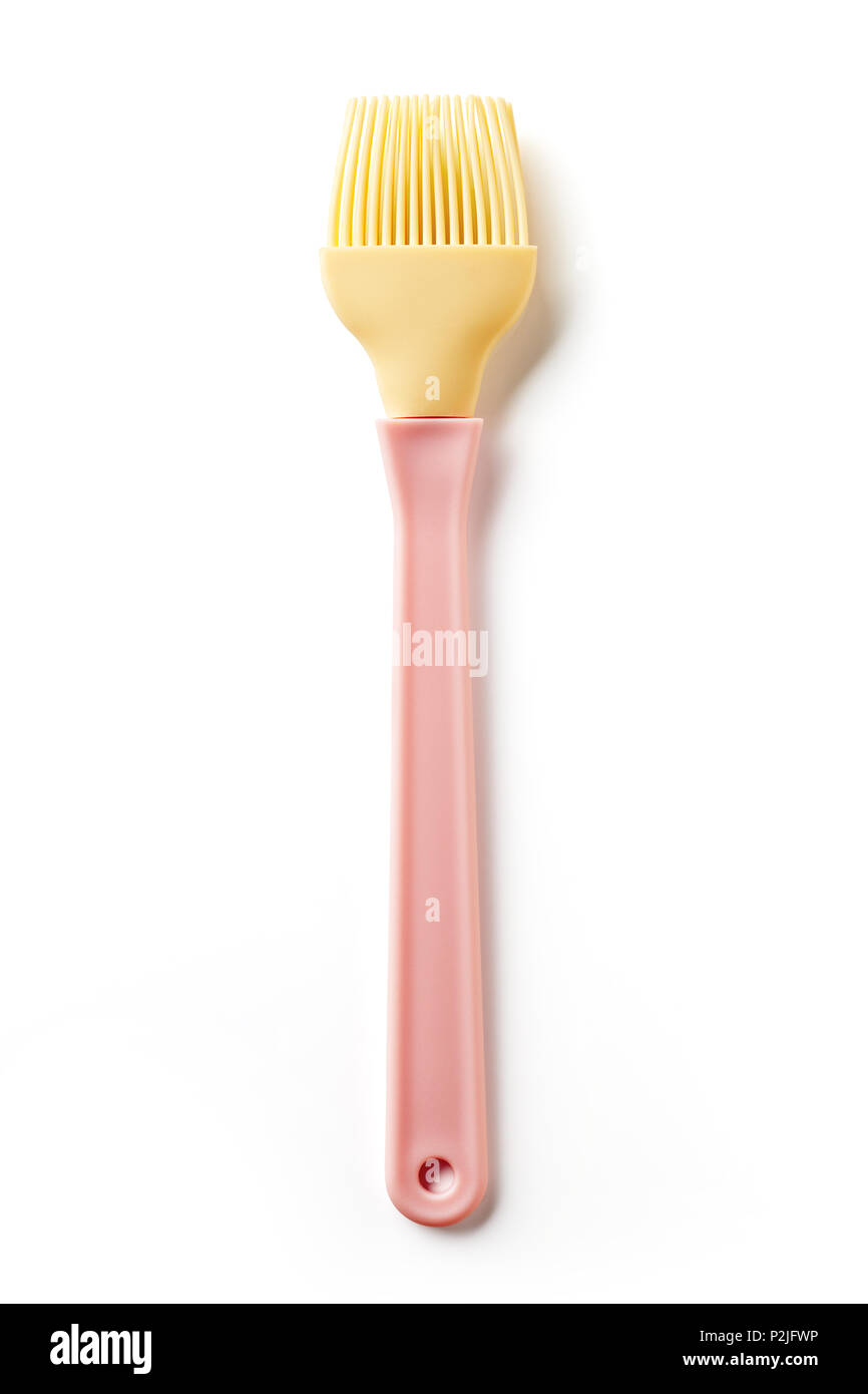 Rose et jaune spatule en silicone isolé sur fond blanc, vue du dessus Banque D'Images