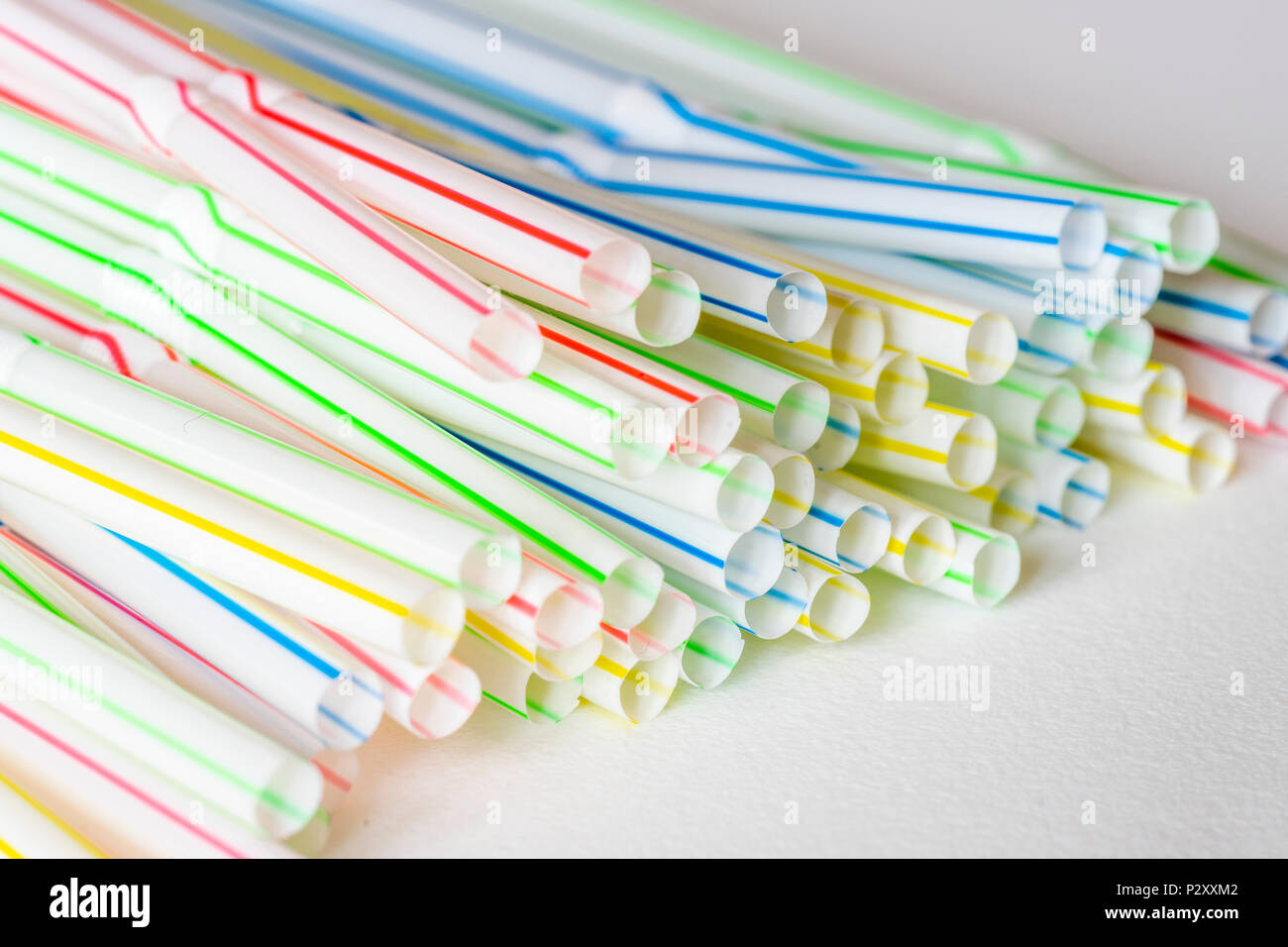 Close up of colorful pailles en plastique contre fond blanc Banque D'Images