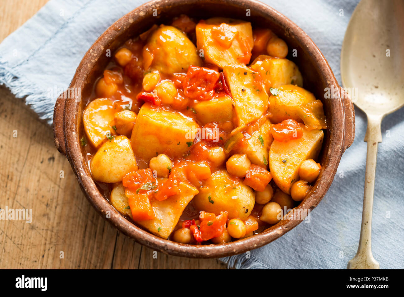 Patatas bravas. Pommes de terre rôties avec des pois chiches dans la sauce tomate. Banque D'Images