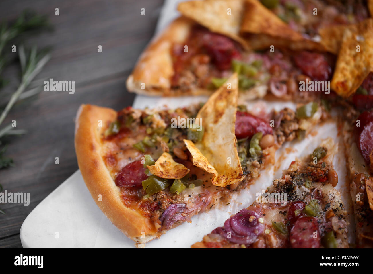 Pizza italien frais. La photographie alimentaire pour la conception. Pizza mexicaine avec les morceaux, l'oignon, piment jalapeno chaud sur une fine couche de pâte classique. Photo gros plan de coupe. Banque D'Images
