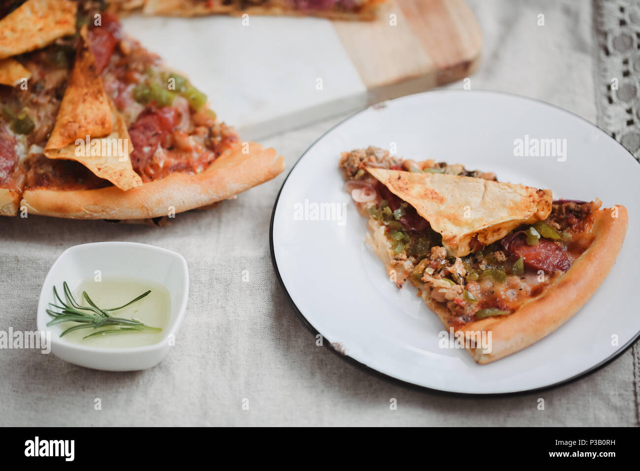 Pizza italien frais. La photographie alimentaire pour la conception. Pizza mexicaine avec les morceaux, l'oignon, piment jalapeno chaud sur une fine couche de pâte classique. Photo gros plan de coupe. Banque D'Images