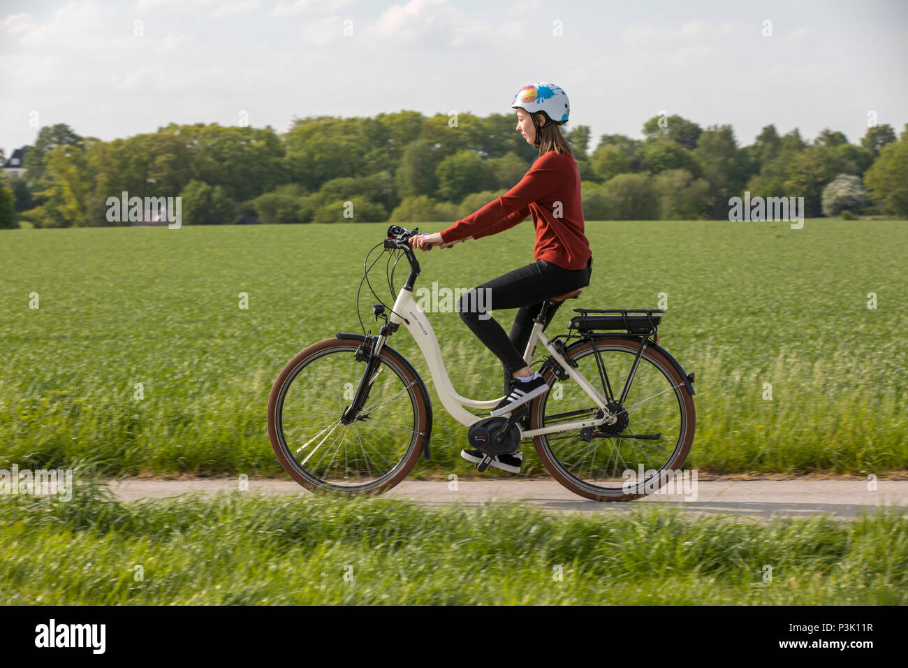 Jeune femme rides un e-bike, vélo électrique, moteur électrique aide à la conduite, Banque D'Images