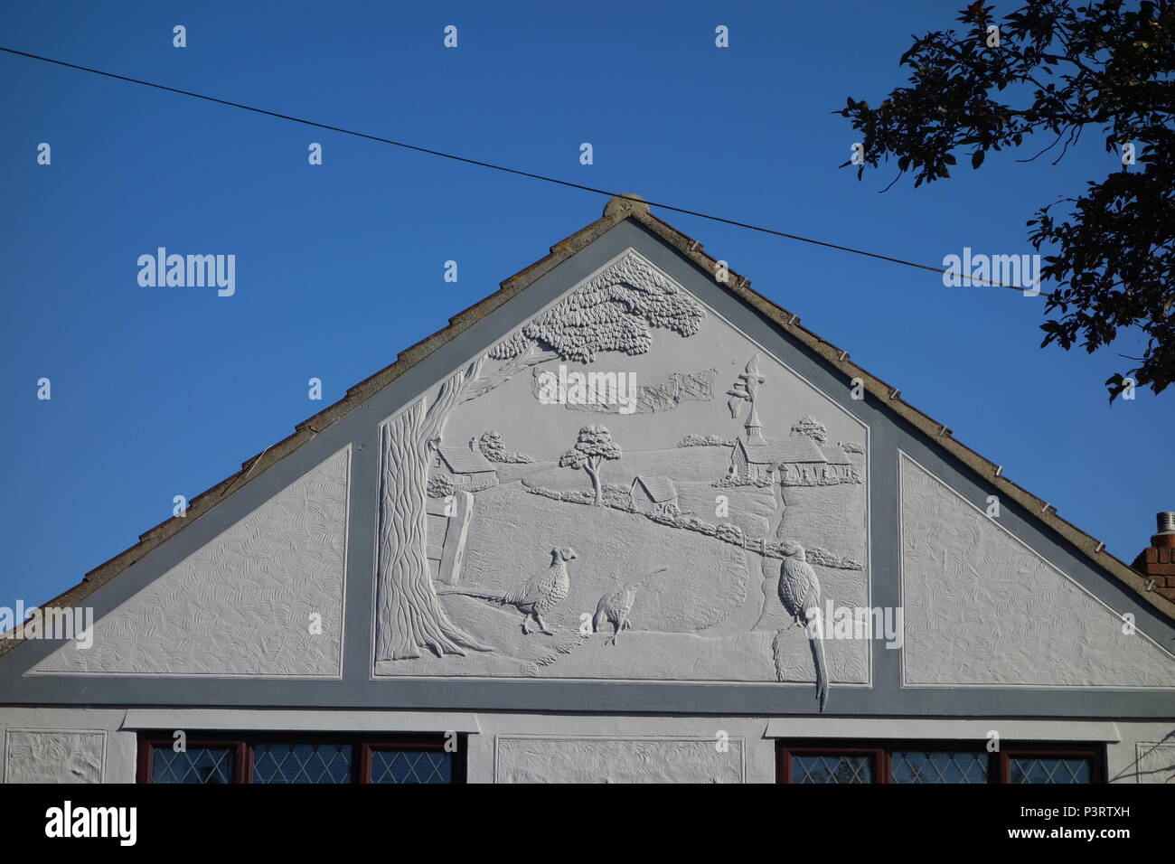 Plâtres modernes et décoratives sur pignon de bungalows en Steeple, south east Essex montrant des scènes sur wildfowling marais à proximité Banque D'Images