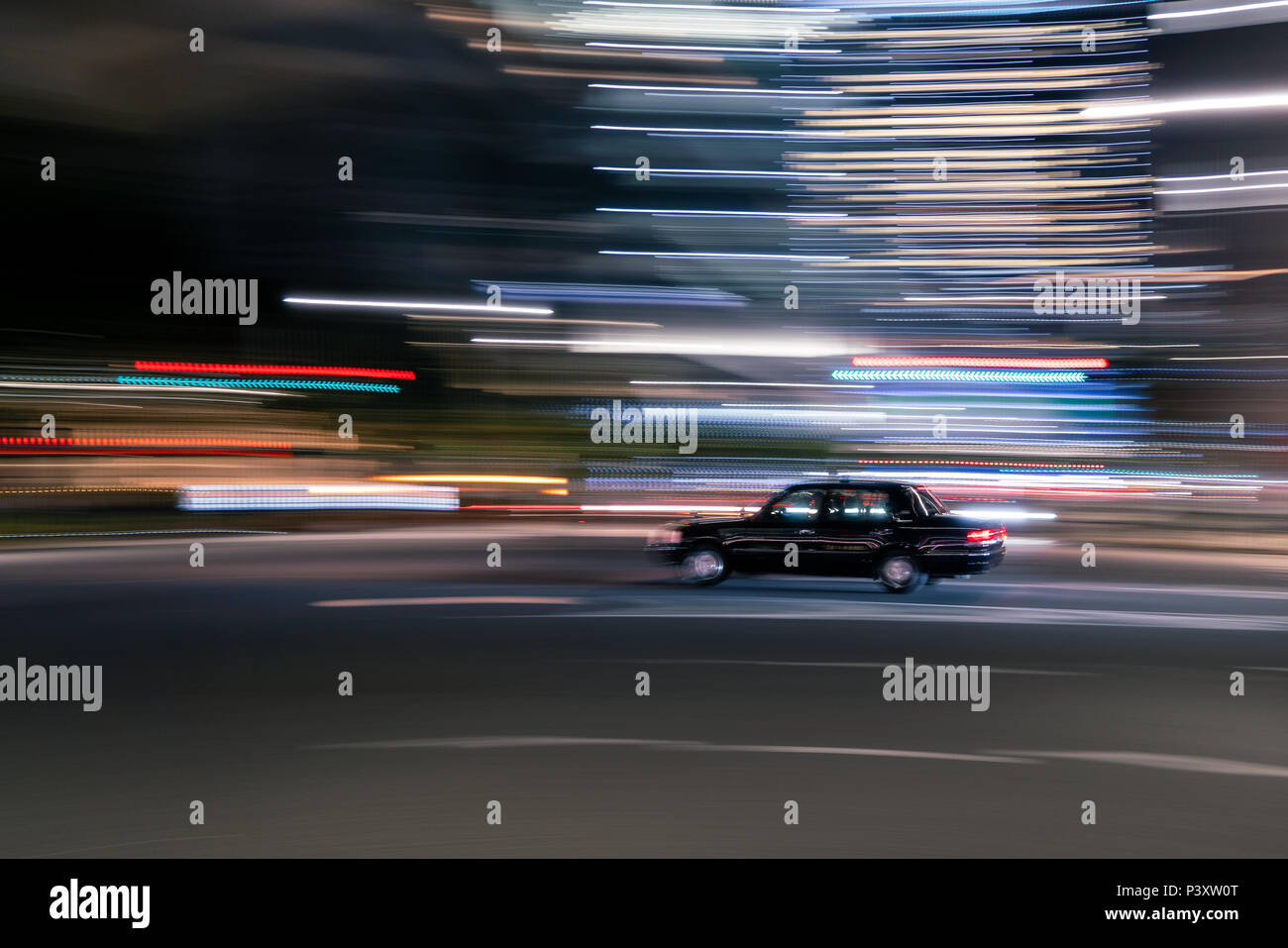 Blurred motion d'un véhicule noir dans une ville Banque D'Images