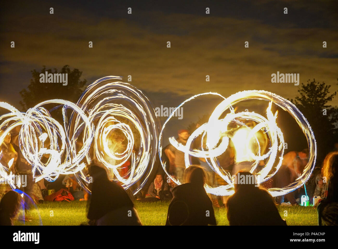 Les jongleurs de feu en gardant les spectateurs au cours de la congélation ver Solstice d'Avebury, Wiltshire nuits en UK Banque D'Images