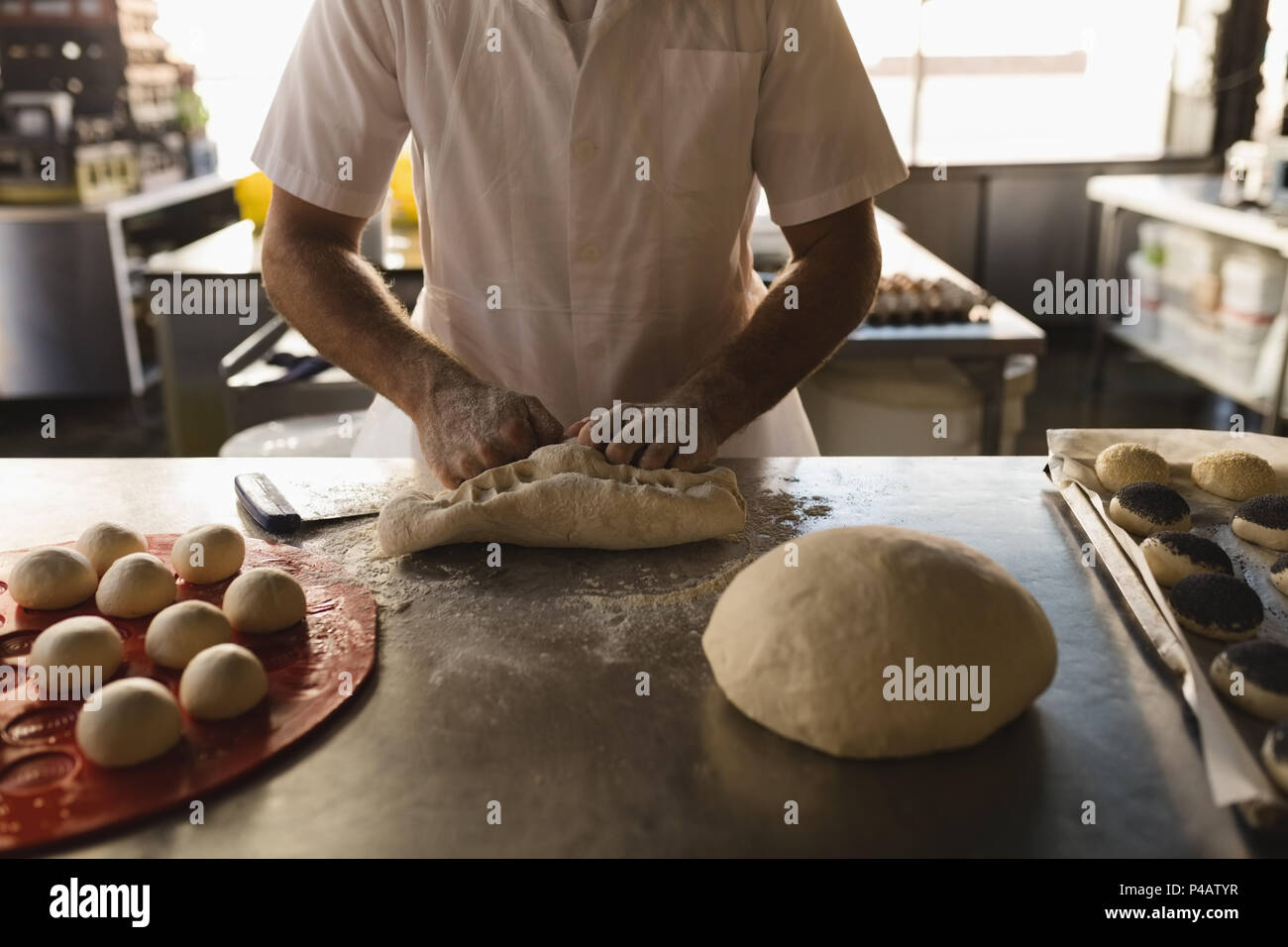 Préparer la pâte en mâle baker bakery shop Banque D'Images
