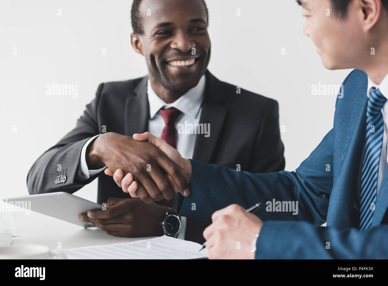 Smiling african american et asian businessman après réunion Banque D'Images