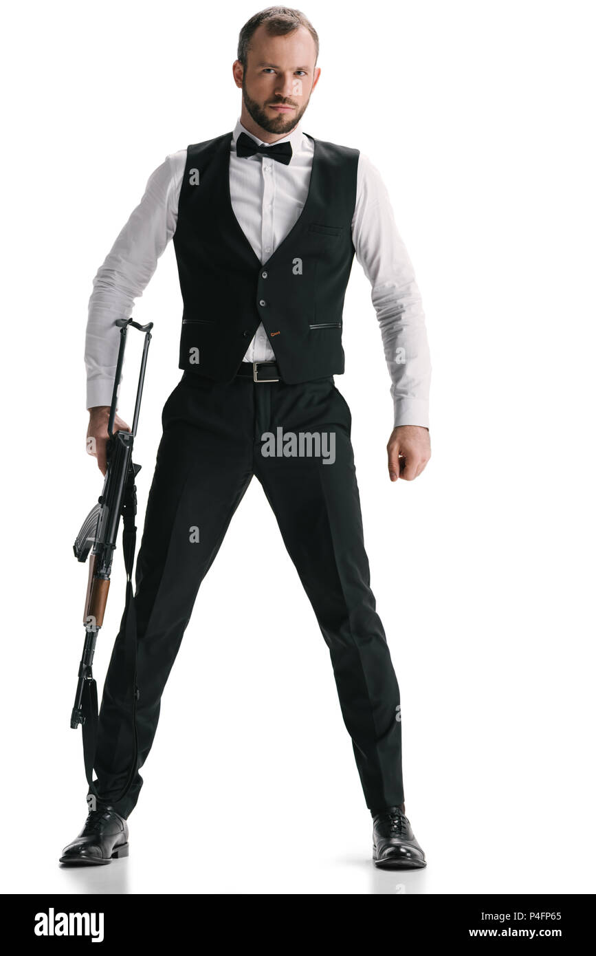 Beau jeune agent secret en costume avec carabine isolated on white Photo  Stock - Alamy