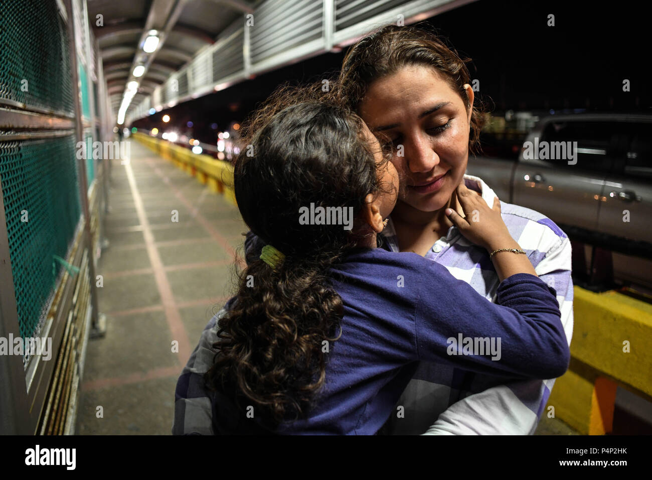 Brownsville, Texas, USA. 22 Juin, 2018. XIOMARA, 24 ans, et sa fille Elizabeth, 5 de San Pedro, Honduras, arrivée le vendredi soir à la frontière entre les États-Unis et le Mexique sur le pont de passerelle internationale, où les agents d'immigration américains essaient de les détourner, disant que les maisons d'hébergement pour demandeurs d'asile étaient pleins. Les agents d'immigration américains ont déplacé leurs opérations à partir d'un emplacement de plusieurs centaines de pieds à l'intérieur du territoire américain à la frontière avec le Mexique sur le pont. Credit : ZUMA Press, Inc./Alamy Live News Banque D'Images