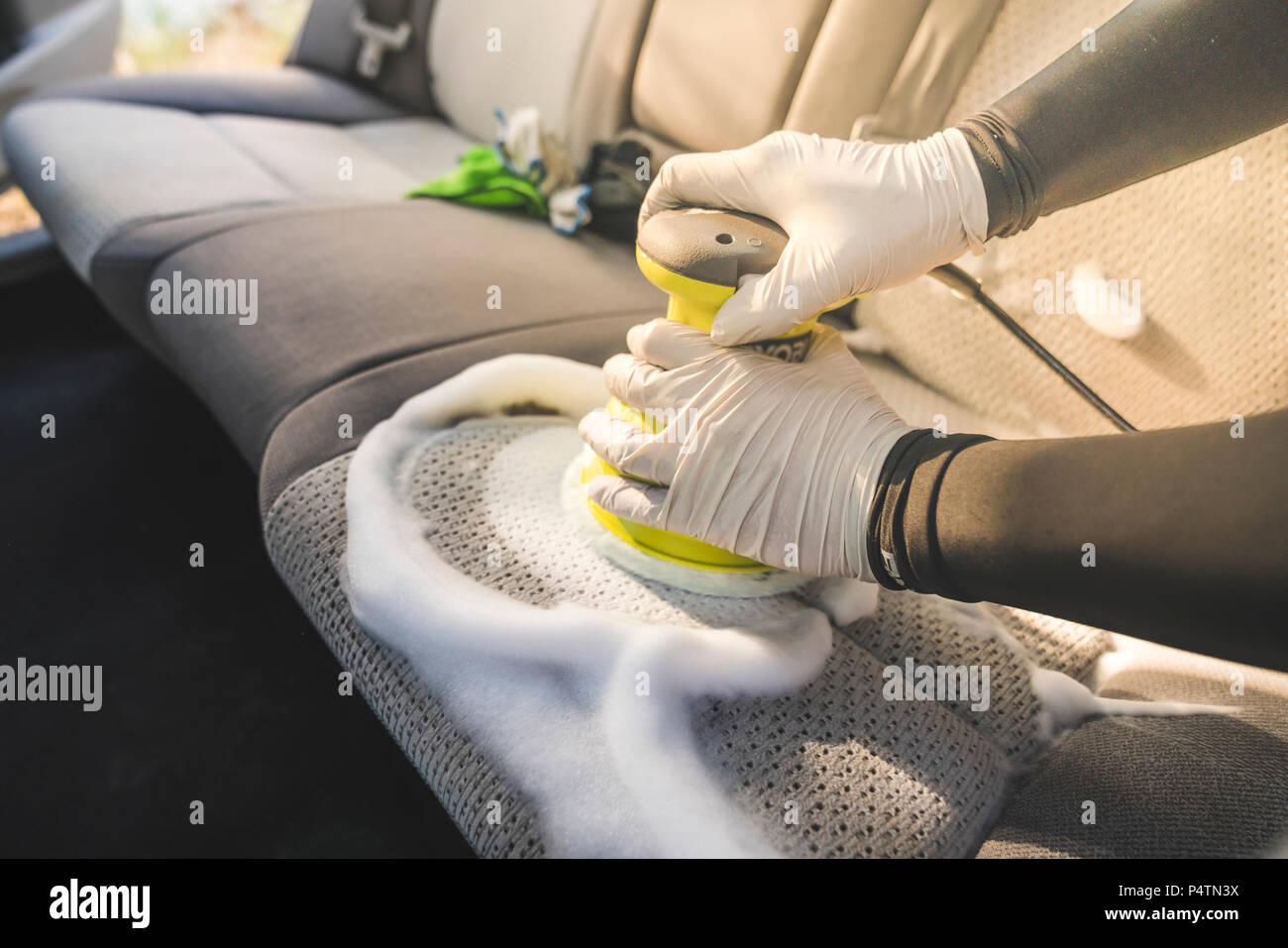 Un homme d'intérieur de voiture de nettoyage par l'utilisation de produits  chimiques de lavage et de mousse machine Photo Stock - Alamy