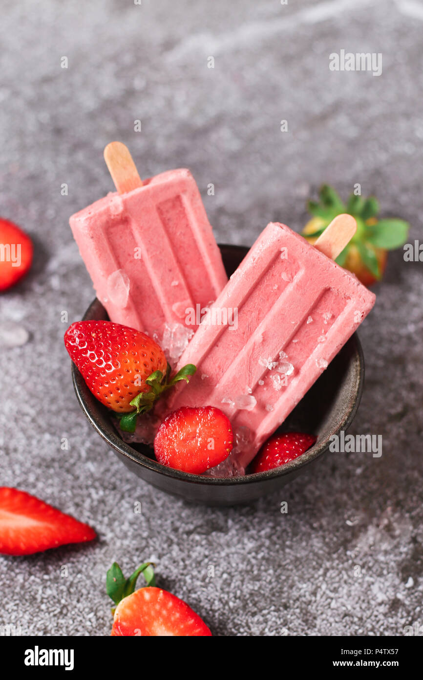 Des sucettes glacées aux fraises dans des bols Banque D'Images