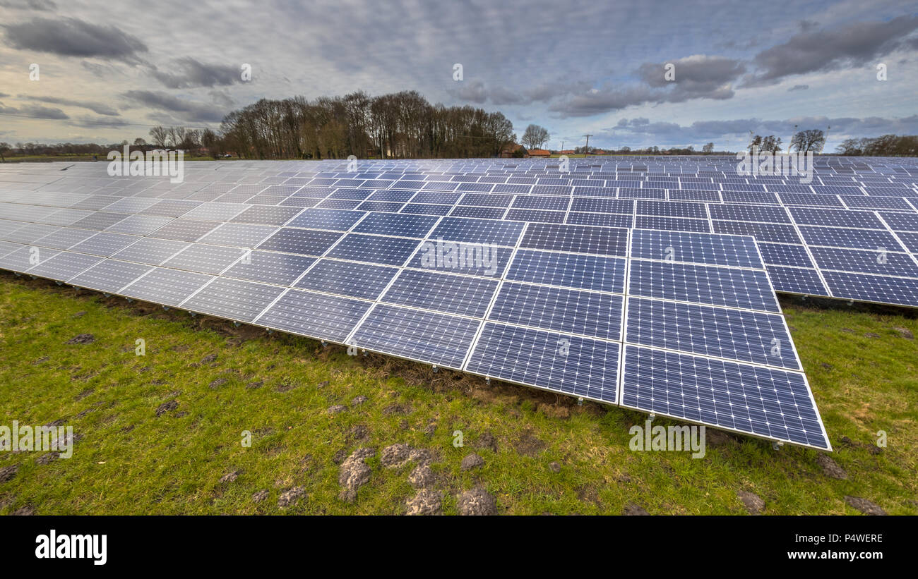 Domaine de l'énergie solaire ,modules photovoltaïques pour l'innovation de l'énergie verte pour la vie avec fond de ciel bleu nuageux. Banque D'Images