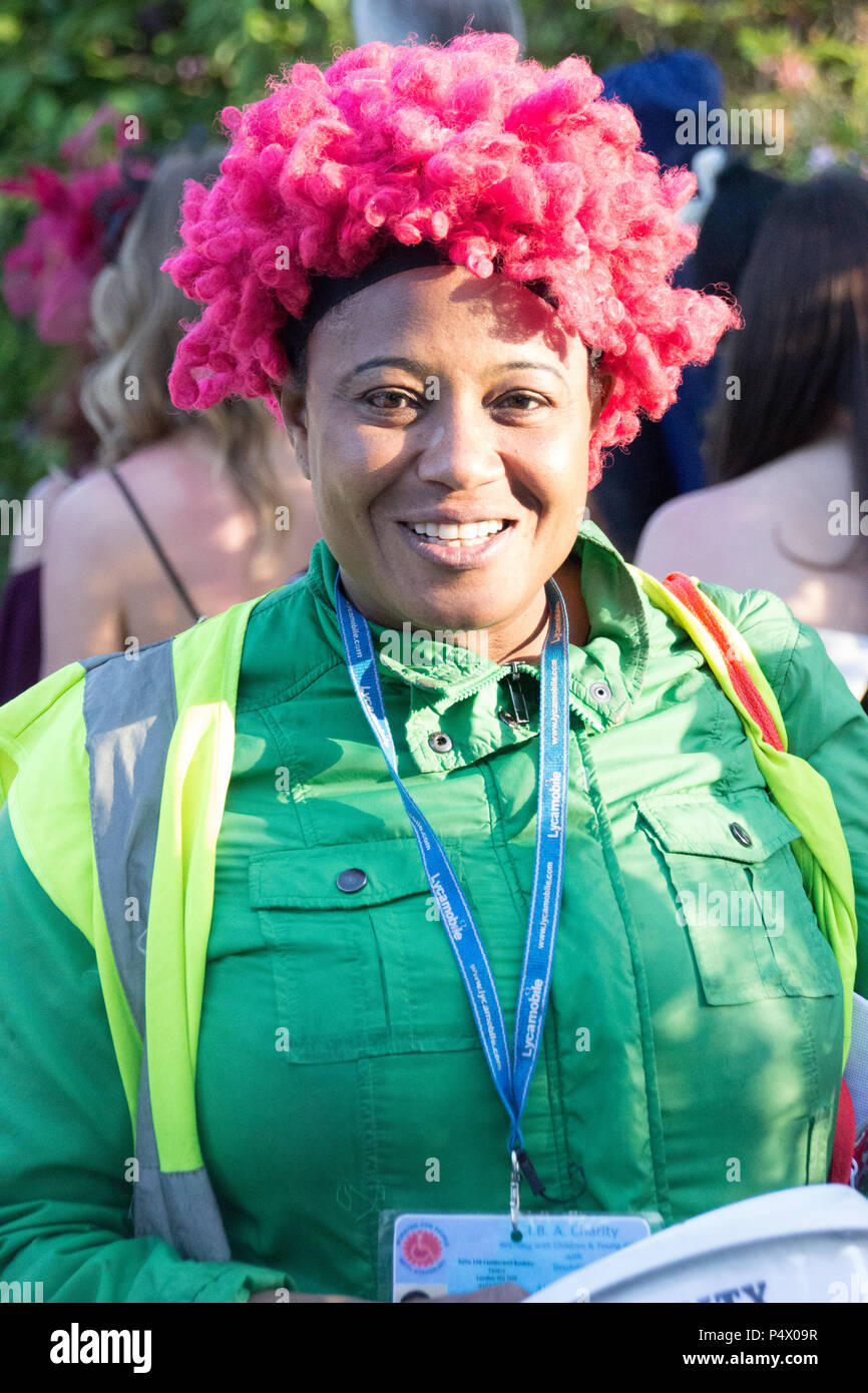 Dame avec teint foncé perruque afro rose la collecte de fonds pour des organismes de bienfaisance à des courses d'Ascot Banque D'Images