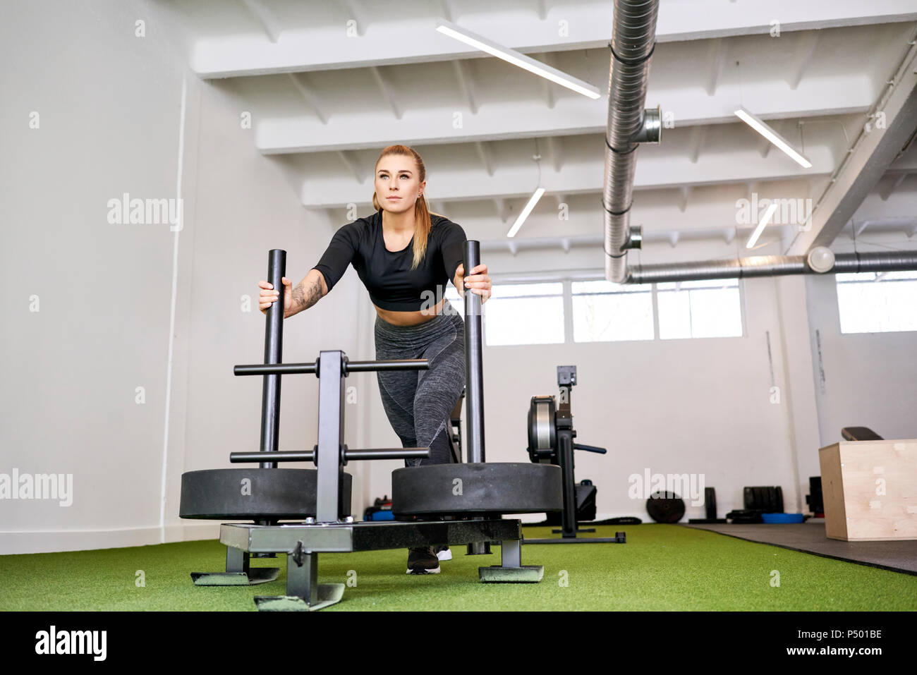 Woman traîneau poids at gym Banque D'Images