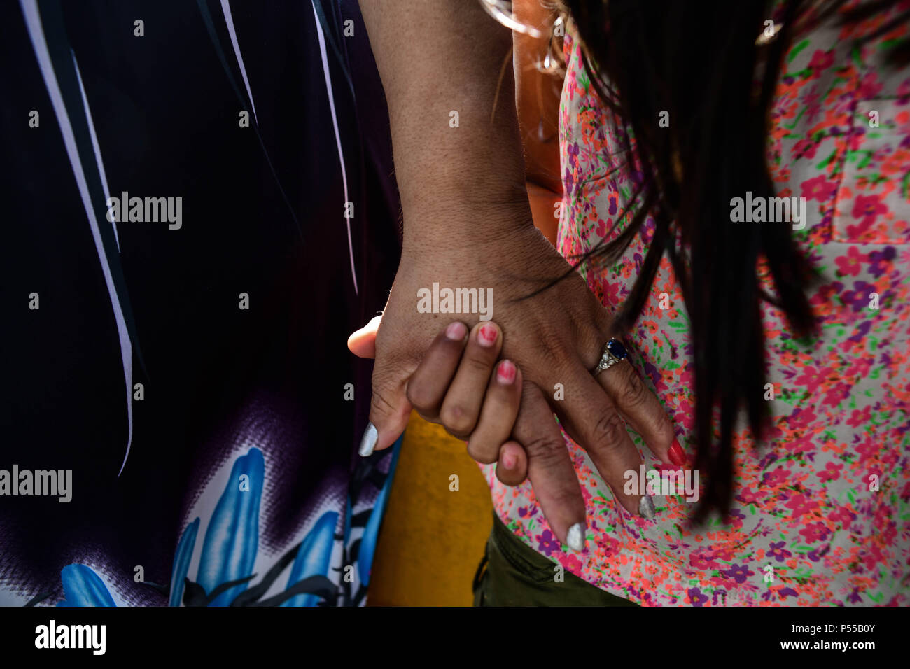 Brownsville, Texas, USA. 24 Juin, 2018. Une femme nommée Irène, du Honduras qui ont refusé de lui donner son nom de famille ainsi que ses filles Alondra, 15, et Valentina, 9 partager une prière avec un groupe religieux qui attendent sur le côté mexicain de la frontière des États-Unis il à demander asile. Plus tard, ils ont été admis. Credit : Miguel Juarez Lugo/ZUMA/Alamy Fil Live News Banque D'Images