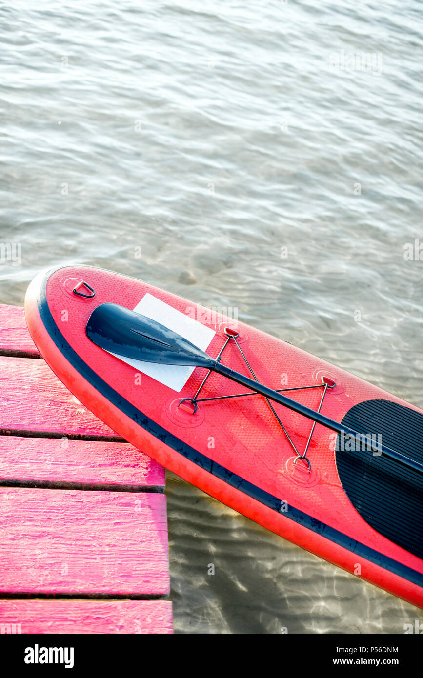Paddleboard rouge au bord du lac Banque D'Images